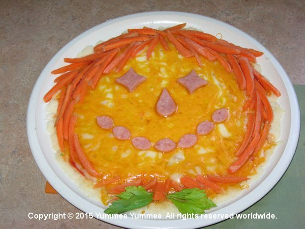A scarecrow with carrot hair. It's a yummee scarecrow pizza.
