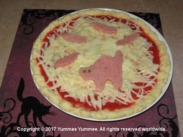 A wickedly scary cat on your pizza from the microwave.